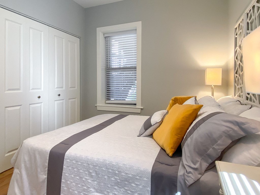 a bedroom with a large bed and a window