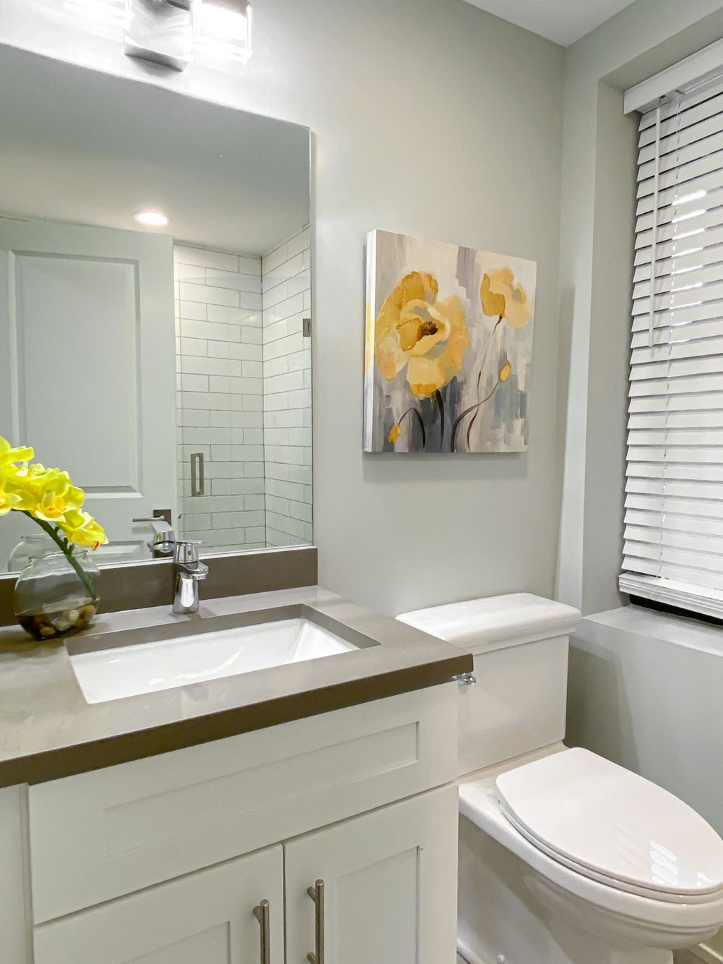 a white bathroom with a sink and a toilet