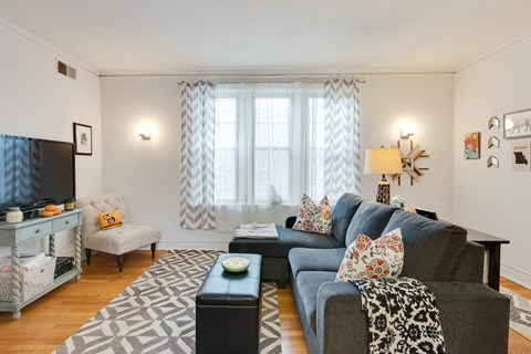 a living room with a blue couch and a tv