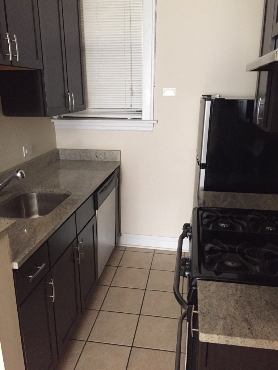 a kitchen with a sink and a refrigerator