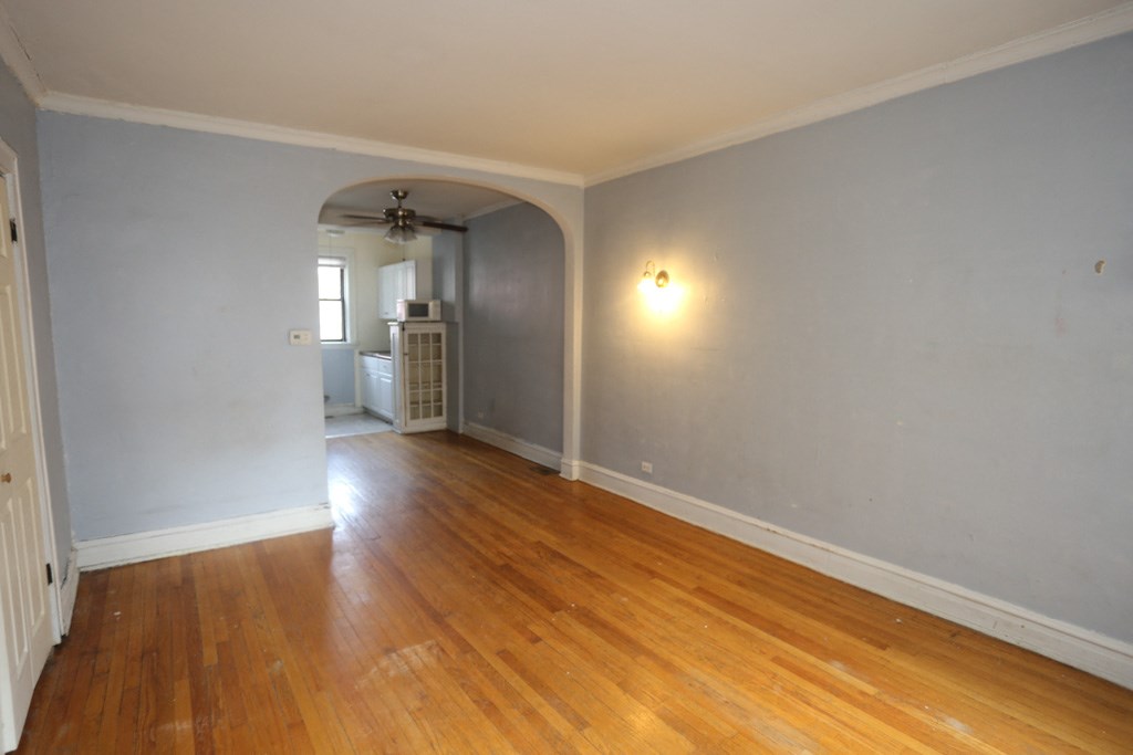 an empty living room with grey walls and wooden floors