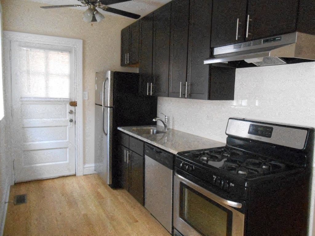 a kitchen with a stove and a refrigerator