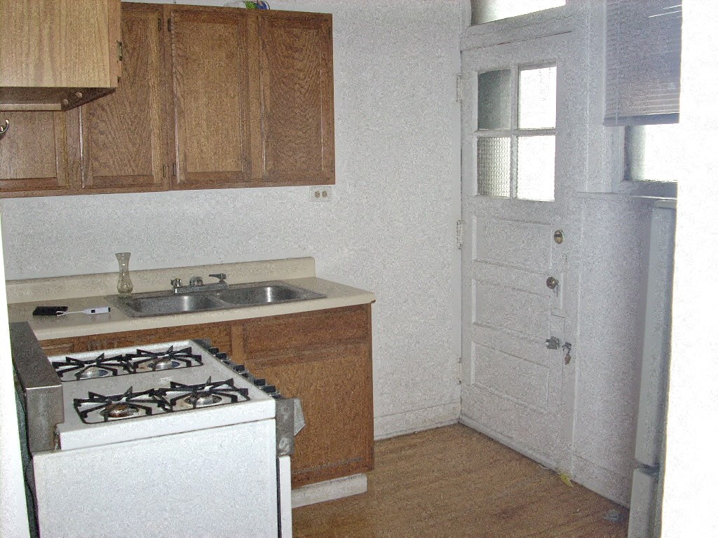 a small kitchen with a stove and a sink