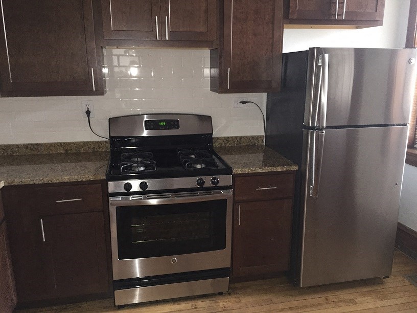 a kitchen with a stove and a refrigerator