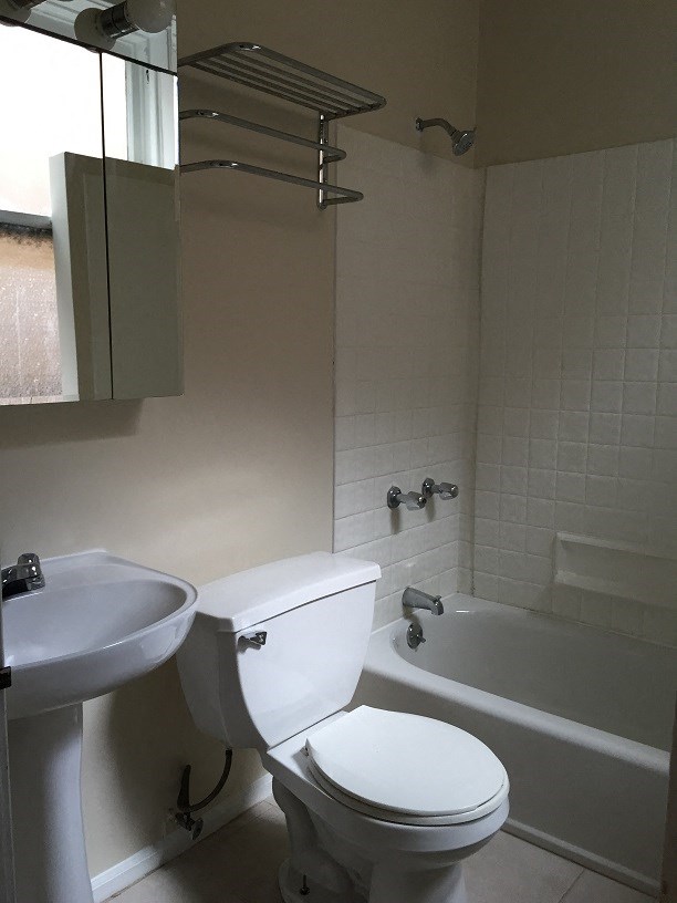 a bathroom with a toilet and a sink and a bath tub