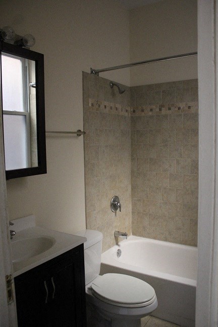 a bathroom with a toilet and a tub and a sink