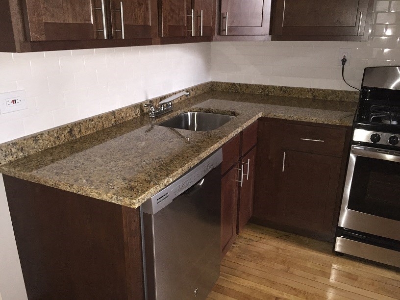 a kitchen with a granite counter top and a sink