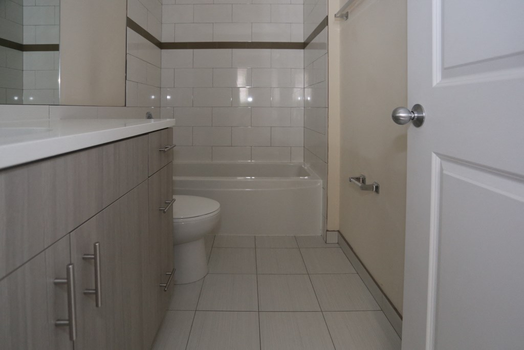 a bathroom with a toilet and a tub and a sink