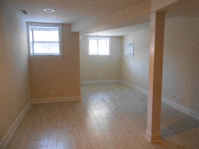 an empty room with a wooden floor and a window