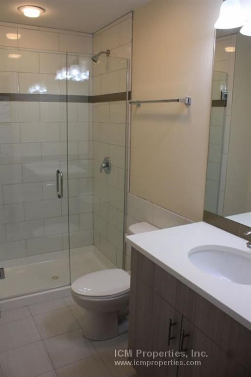 a bathroom with a toilet and a sink and a shower