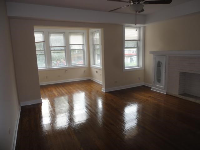 a living room with a fireplace and a wooden floor