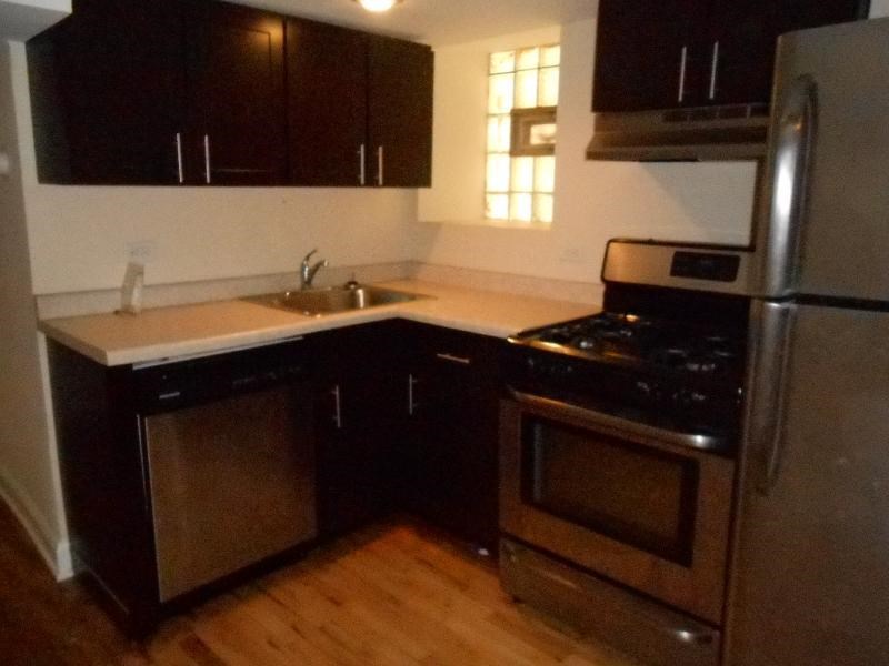 a kitchen with a stove and a refrigerator and a sink