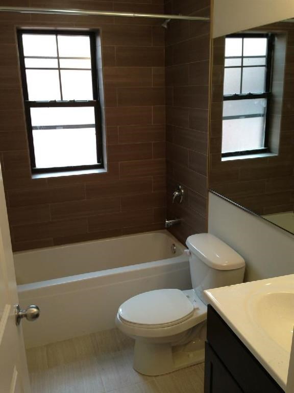 a bathroom with a toilet and a bath tub