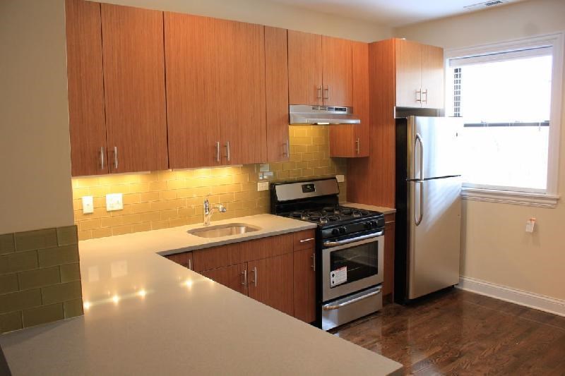 a kitchen with a stove refrigerator and a sink