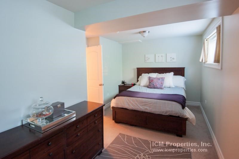 a bedroom with a bed and a dresser and a window