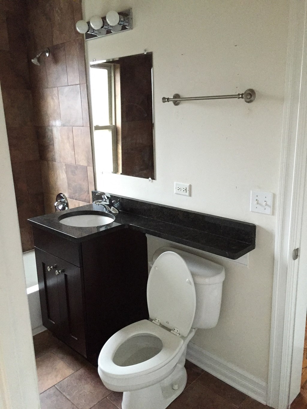 a bathroom with a toilet and a sink and a mirror