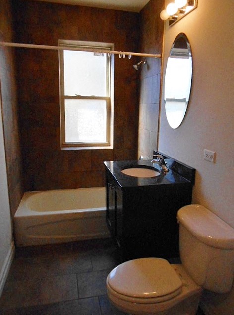 a bathroom with a toilet and a sink and a bath tub