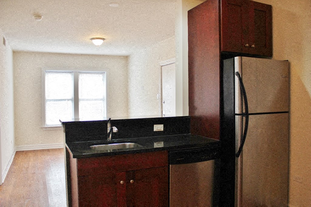 a kitchen with a sink and a refrigerator