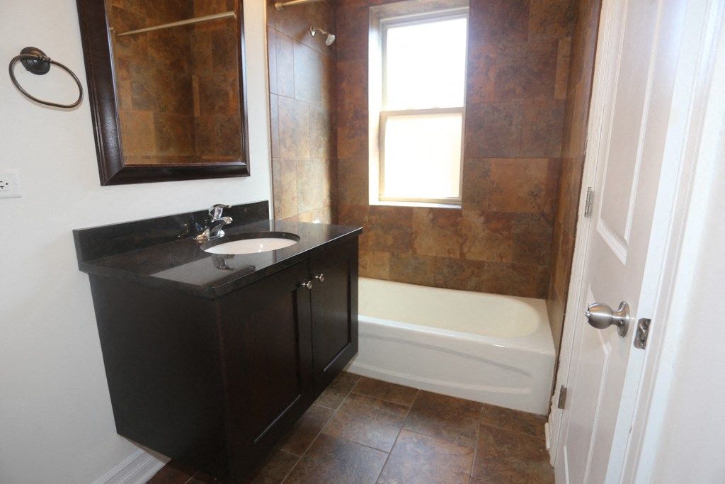 a small bathroom with a sink and a bath tub
