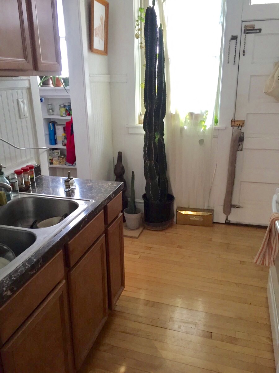 a kitchen with a sink and a window and a bamboo floor