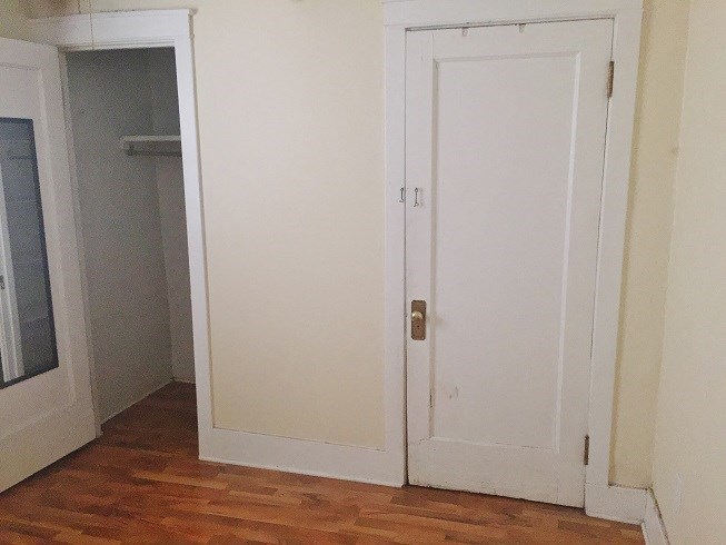 a white door in a room with a closet