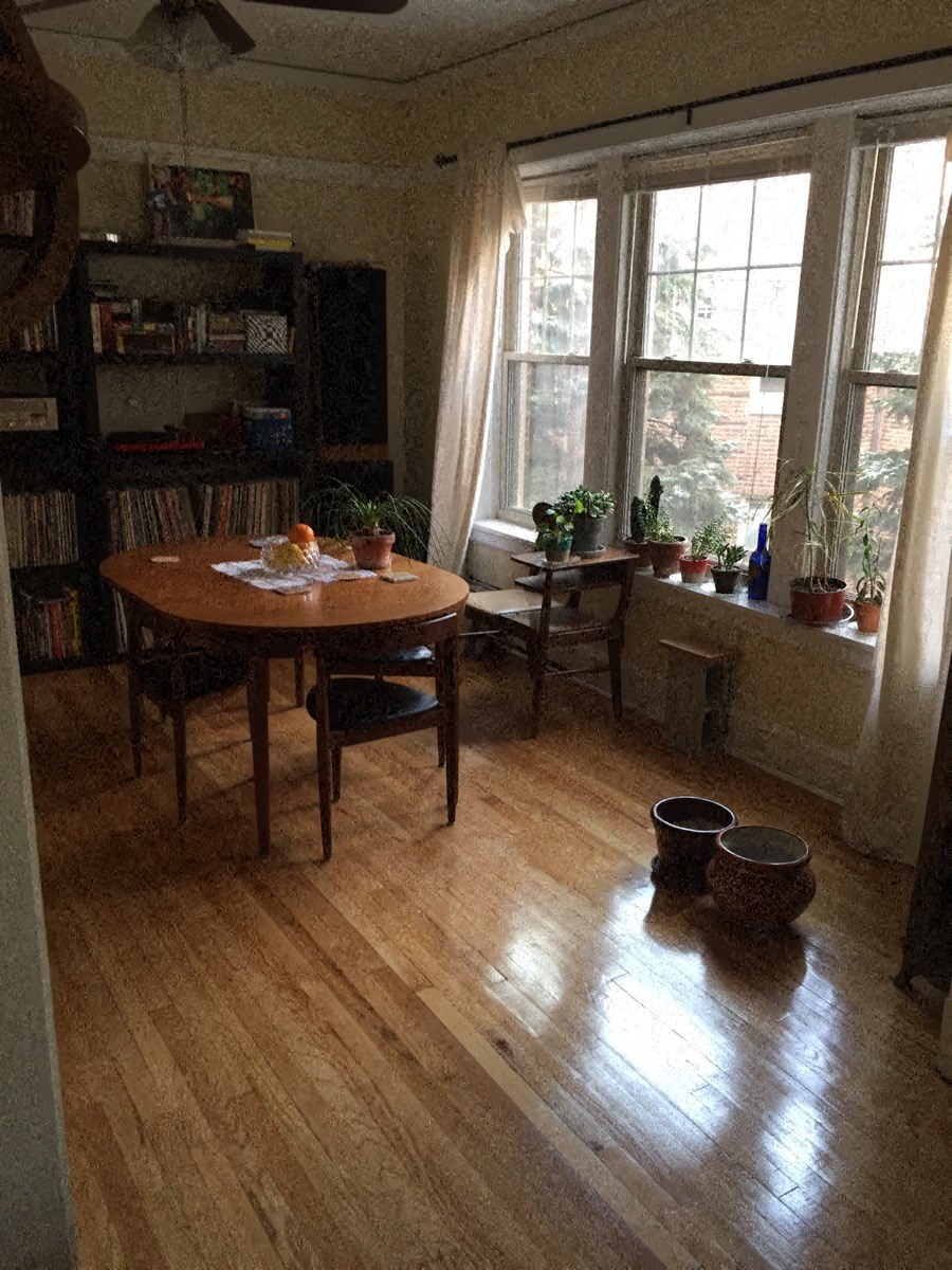a dining room with a wooden floor and a table