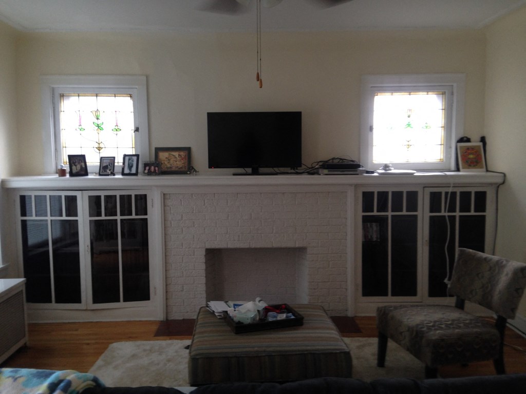 a view of the living room with the fireplace and tv
