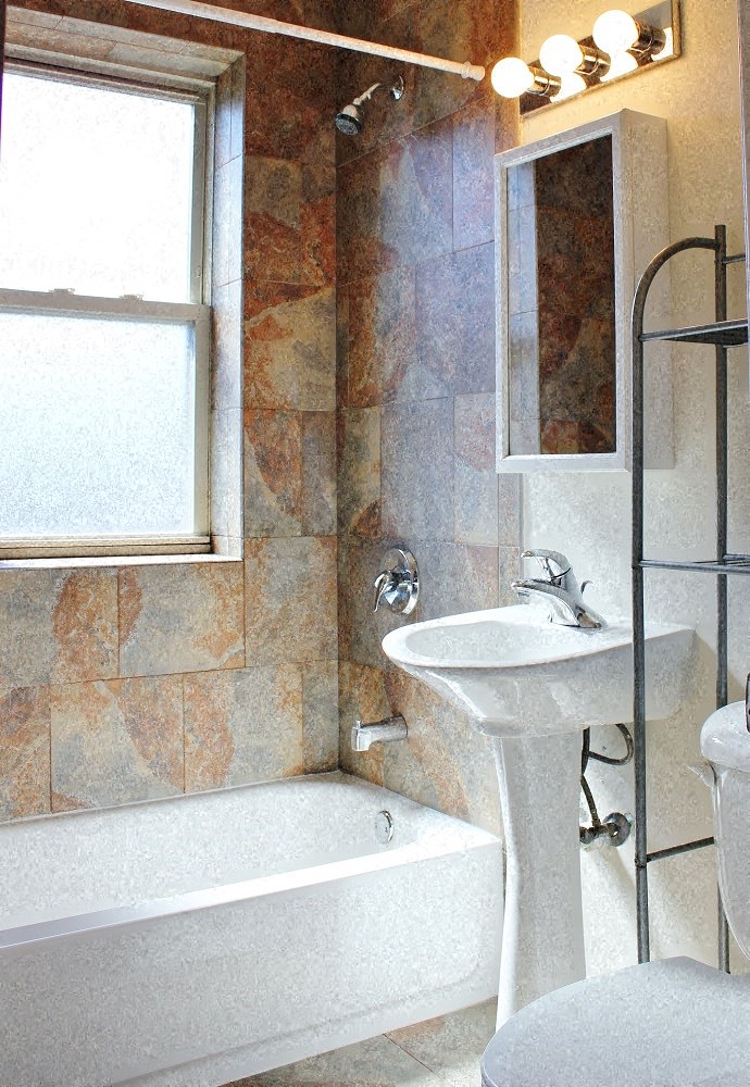 a bathroom with a sink and a tub and a window
