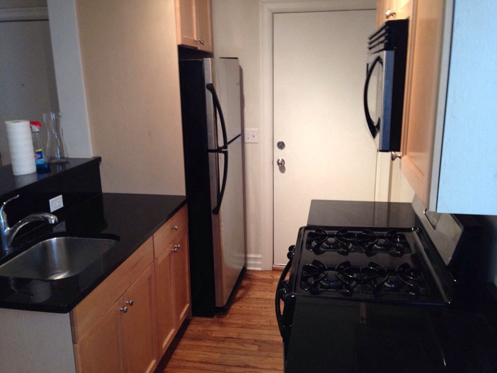 a small kitchen with a stove and a refrigerator