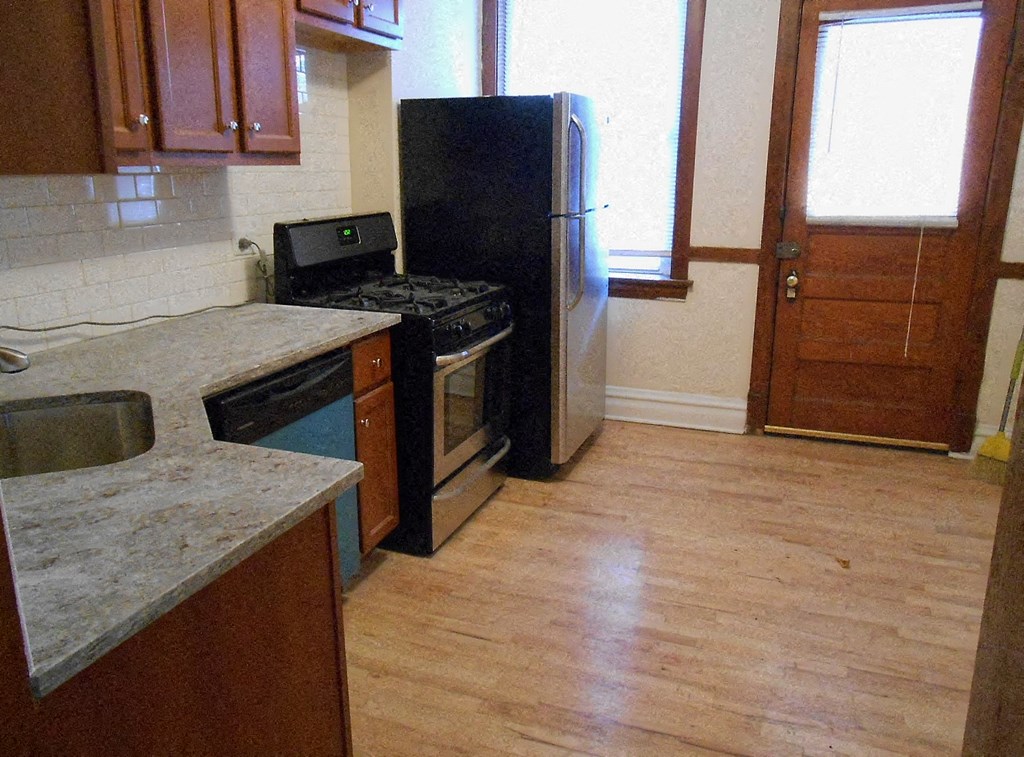 a kitchen with a stove and a refrigerator