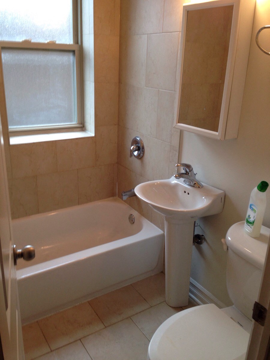 a small bathroom with a sink toilet and bath tub