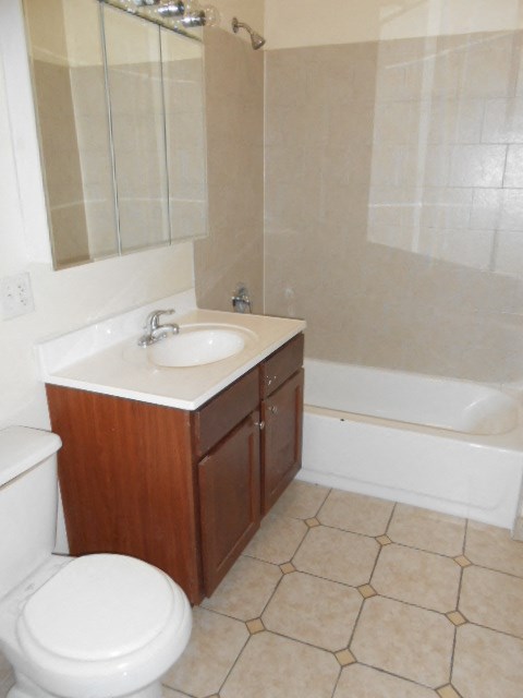 a bathroom with a sink toilet and a bath tub