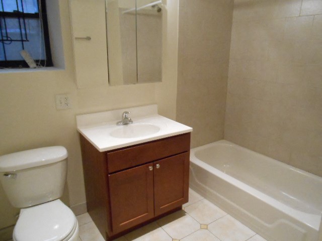 a bathroom with a sink toilet and a bath tub