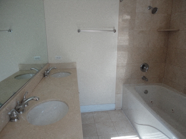 a bathroom with two sinks and a bath tub