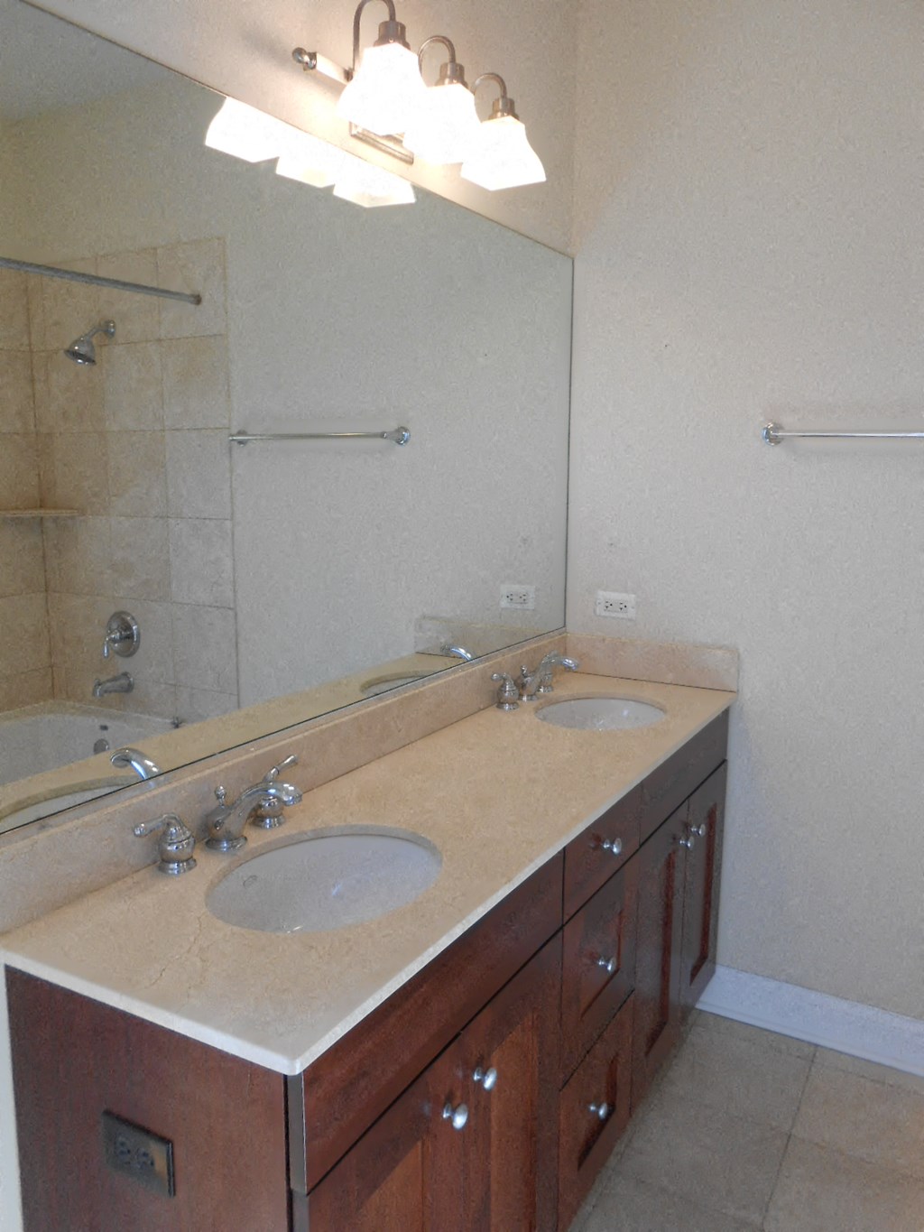 a bathroom with two sinks and a large mirror