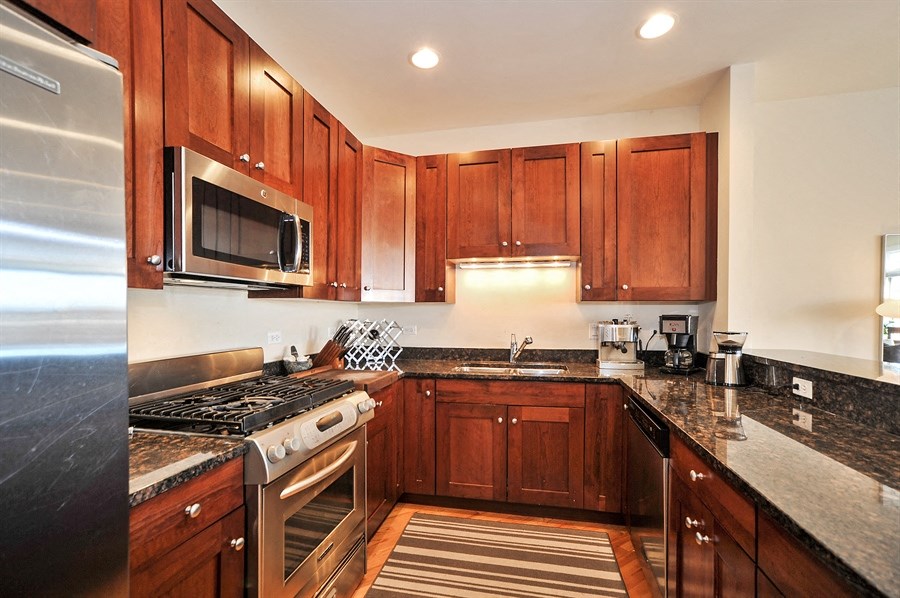 a kitchen with wood cabinets and stainless steel appliances and granite counter tops
