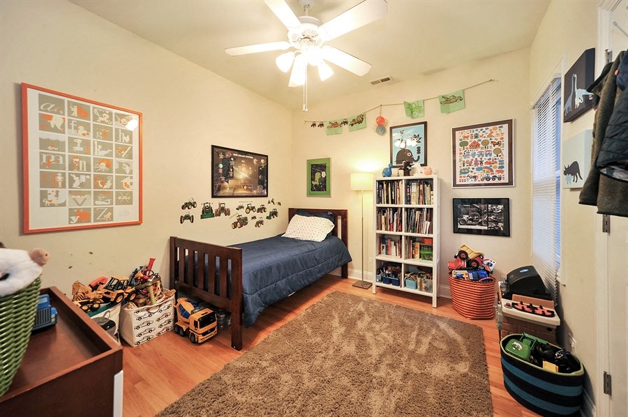 a bedroom with a bed and a ceiling fan