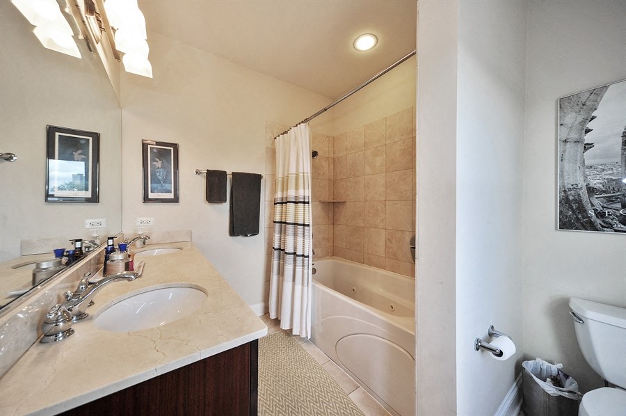 a bathroom with a sink and a shower and a toilet