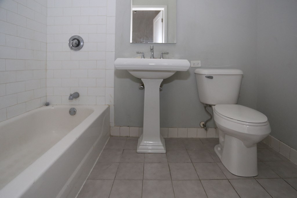a bathroom with a sink toilet and bath tub