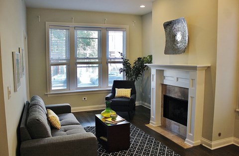 a living room with a couch and a chair and a fireplace