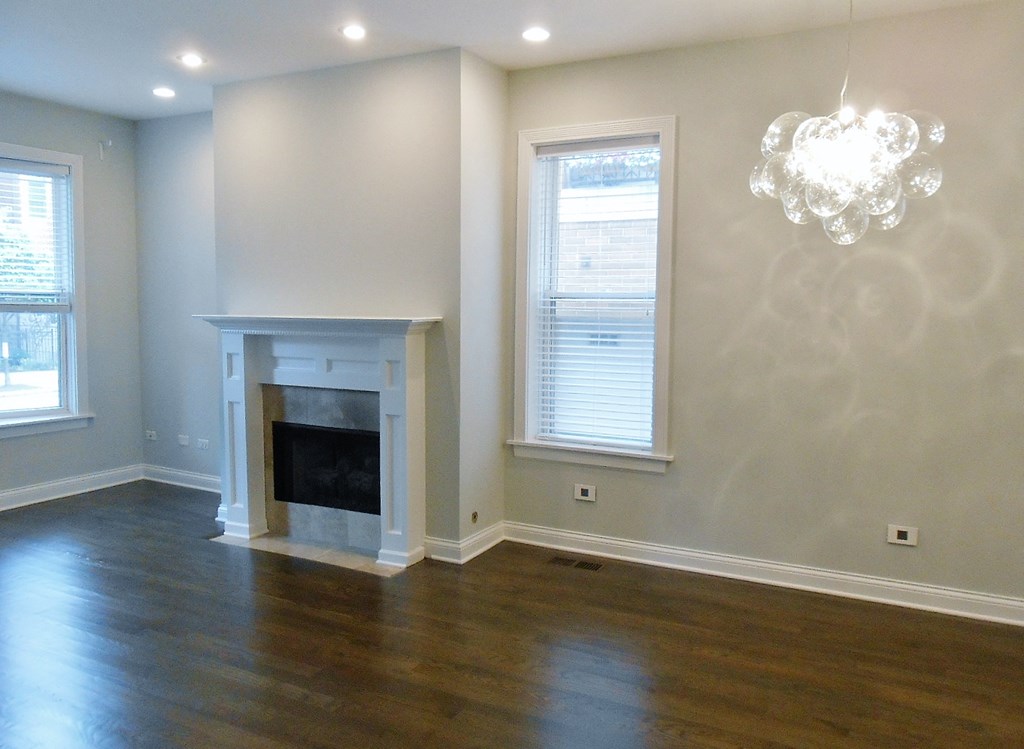 a living room with a fireplace and a chandelier