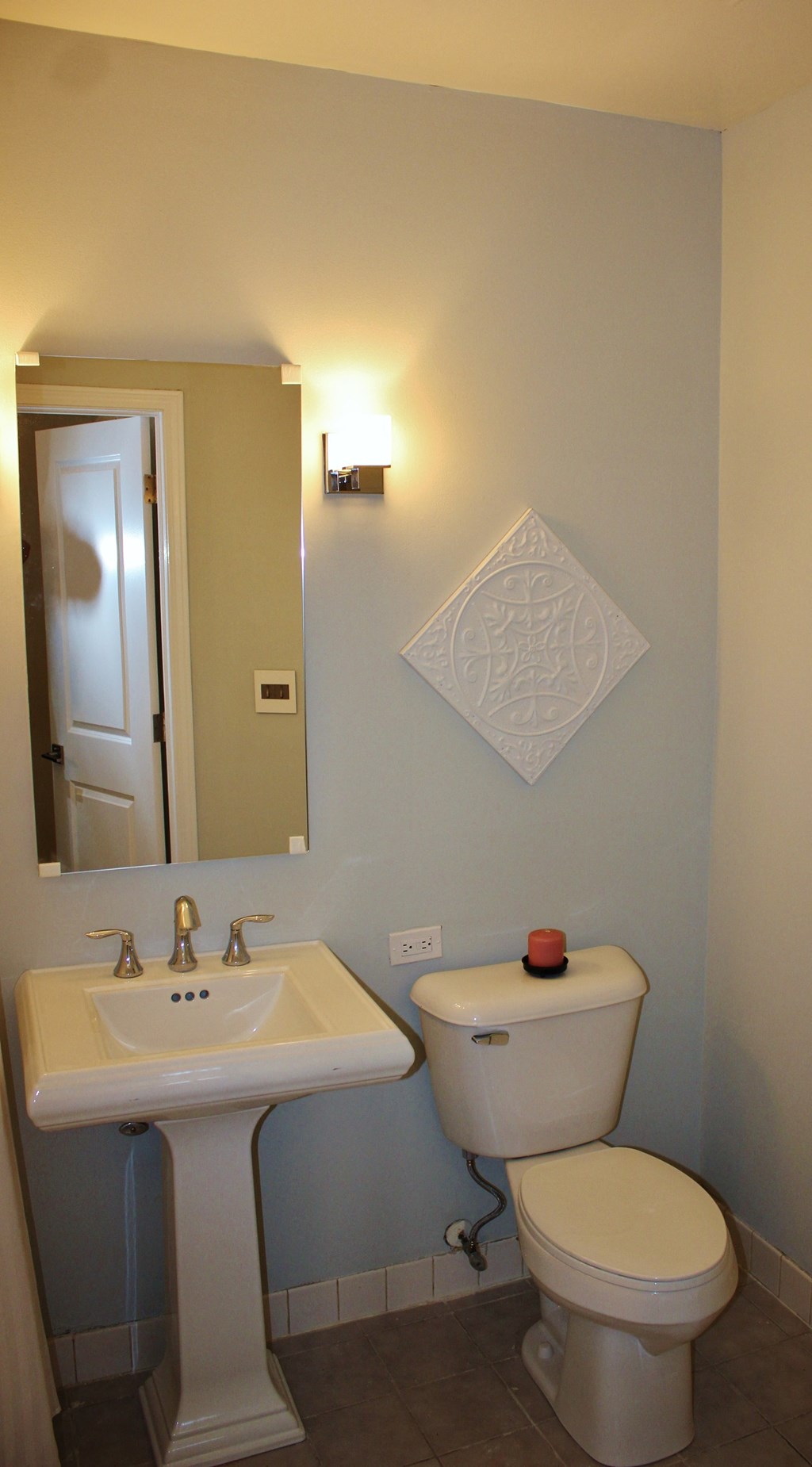 a bathroom with a toilet and a sink and a mirror