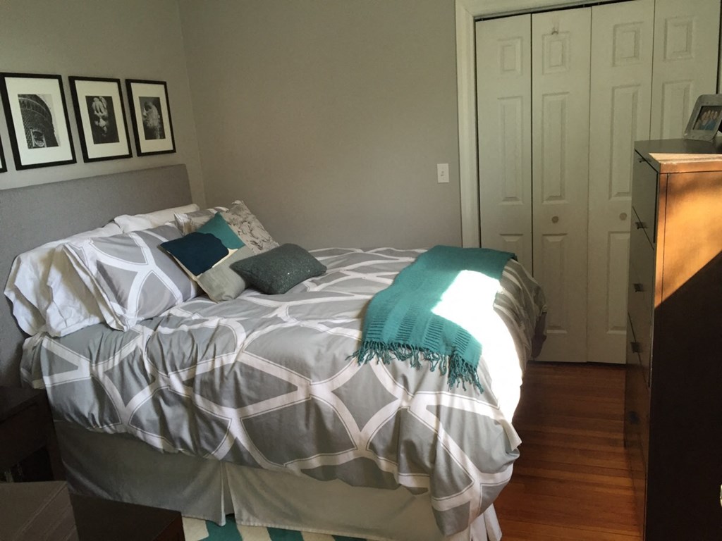 a bedroom with a bed and a dresser