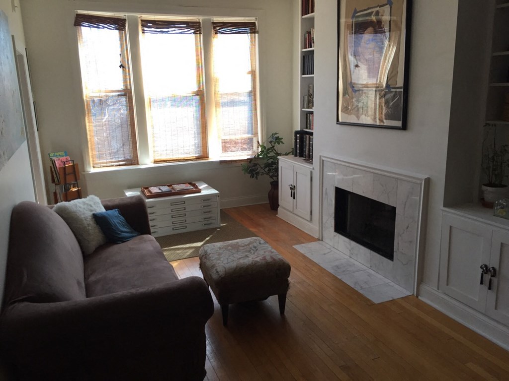 a living room with a couch and a fireplace