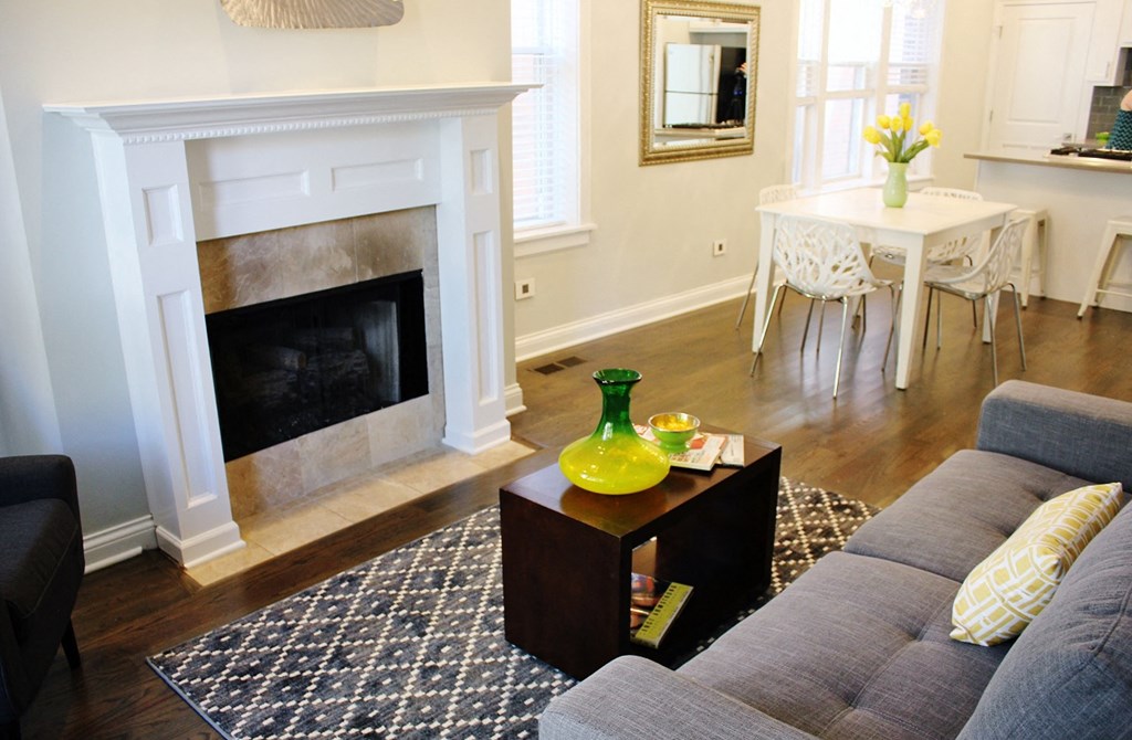 a living room with a couch and a table and a fireplace