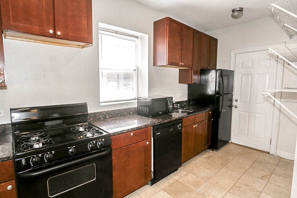 a kitchen with a stove refrigerator and a sink
