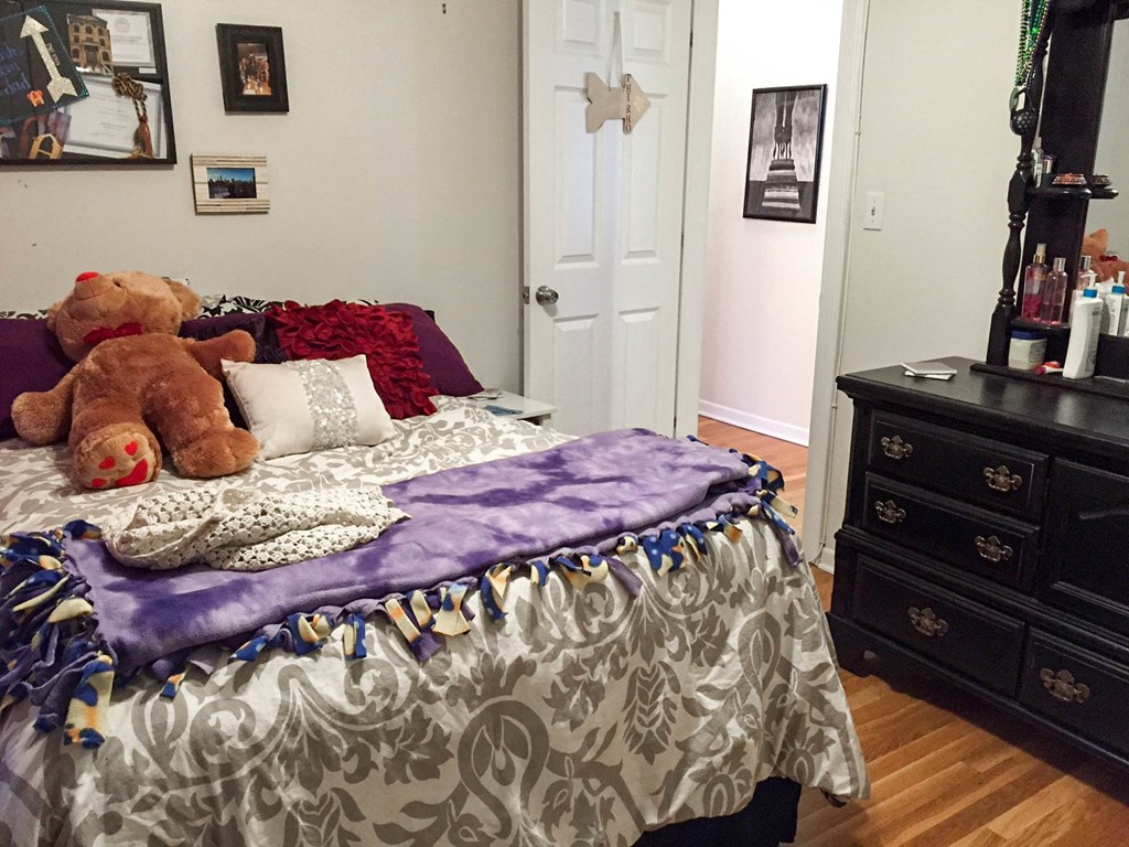 a bedroom with a bed with teddy bears on it
