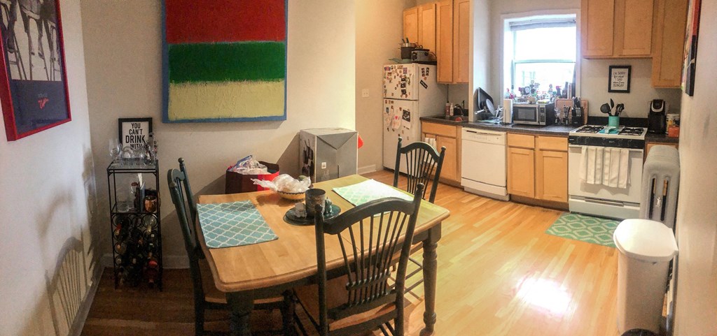 a kitchen and dining room with a table and chairs