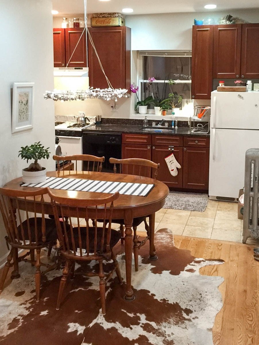 a kitchen with a table and chairs in it