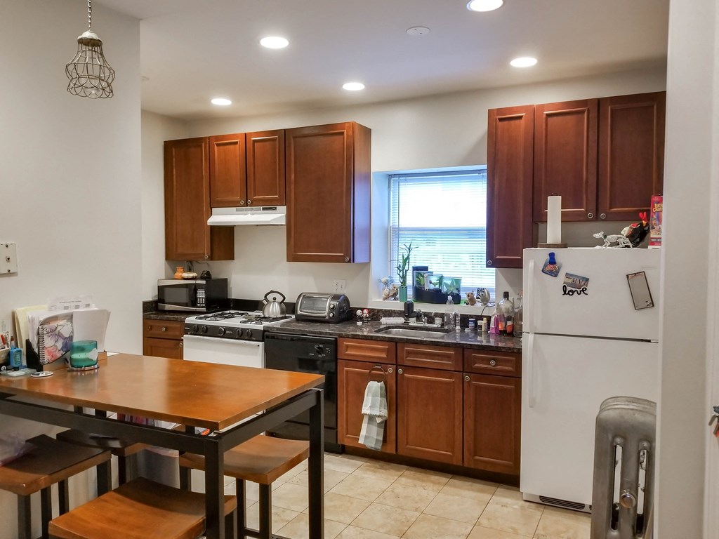 a kitchen with a dining table and a refrigerator